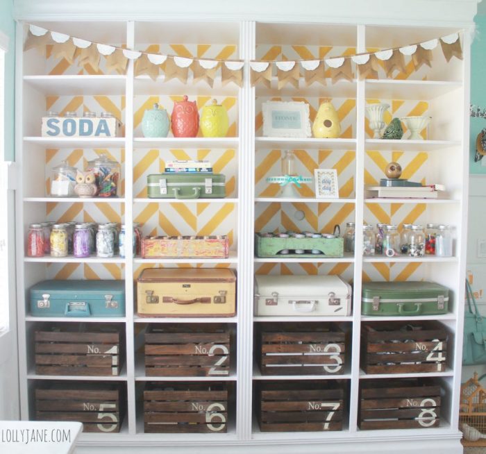 Paint a bookcase a herringbone stencil, use mason jars, crates and suitcases for storage!