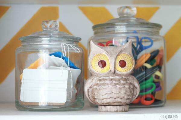 So cute! Glass jars from Ikea for scissor and craft supply storage paired with a vintage owl! #craftroom #organization