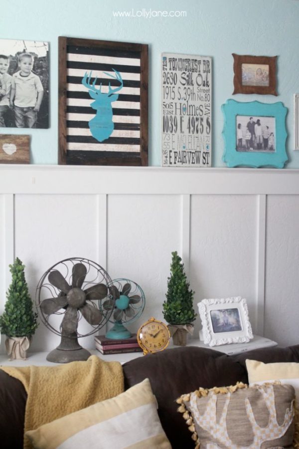 Cute gallery wall in mustards & turquoise! LOVE that striped deer head sign!