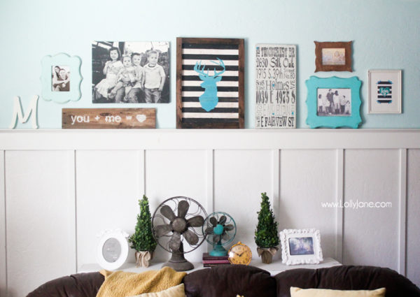 Cute gallery wall in mustards & turquoise! LOVE that striped deer head sign!