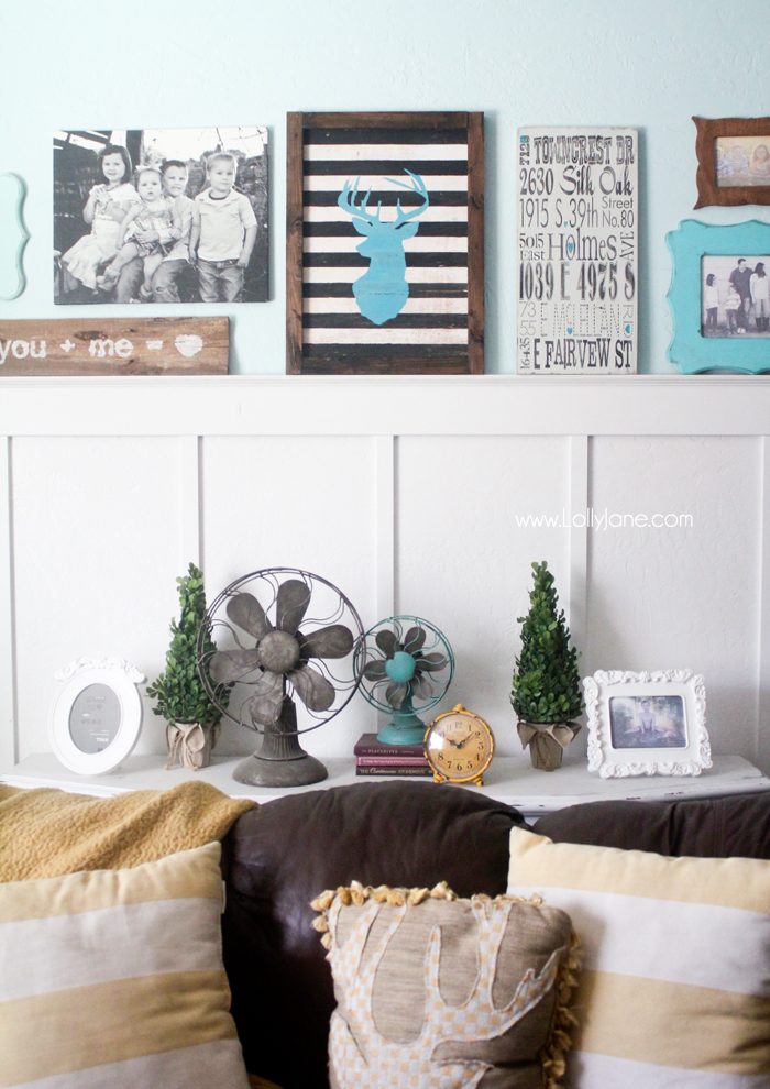 Cute gallery wall in mustards & turquoise! LOVE that striped deer head sign!