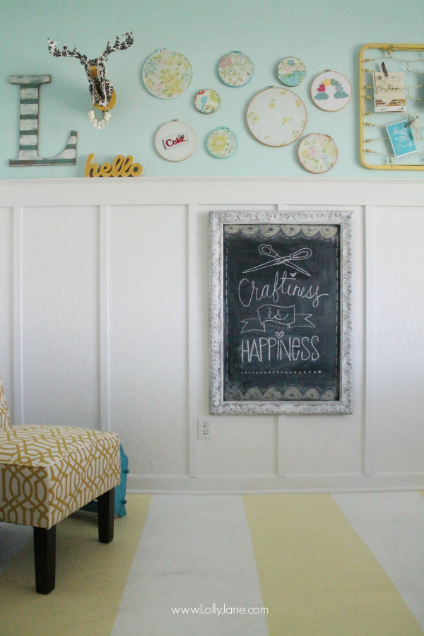 Use embroidery hoops and old fabric for easy wall decor in a colorful craft room! @lollyjaneblog