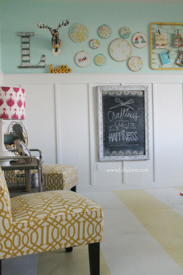 Fun "Happiness is Craftiness" chalkboard in a cute, colorful craft room!