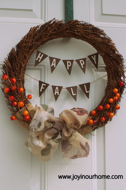 Such a cute diy fall wreath! We love this easy to make Happy Fall Wreath using a grapevine wreath form. This is a simple fall wreath using card stock, burlap and berry sprigs, cute! #diy #falldecor #fallwreath #wreath #wreathcraft #fallcraft #falldecoration #howtomakeafallwreath #wreathdecor