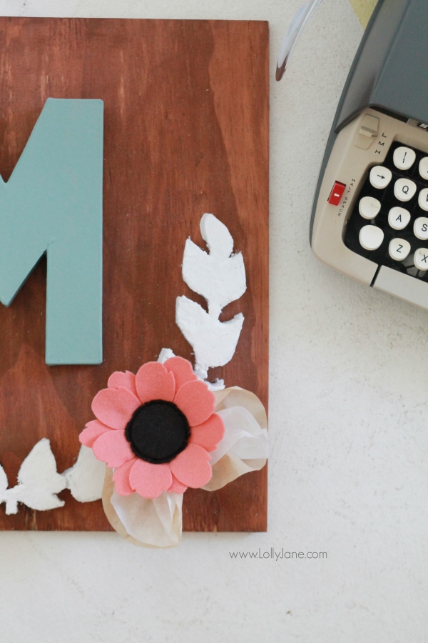 DIY project |Make this pretty monogram sign out of a surprise material: foam! Cute home decor that's easy to make!  So cute with mixed media felt flowers and coffee filter leaves. A great how-to on lollyjane.com