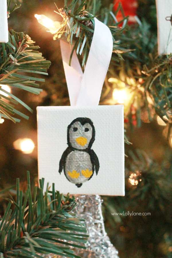 ADORABLE mini canvas thumbprint ornaments! SO EASY to make, kids have fun crafting and you get a Christmas keepsake for years to come. Great Christmas kids craft and Christmas gift idea! Love this penguin thumbprint ornament!