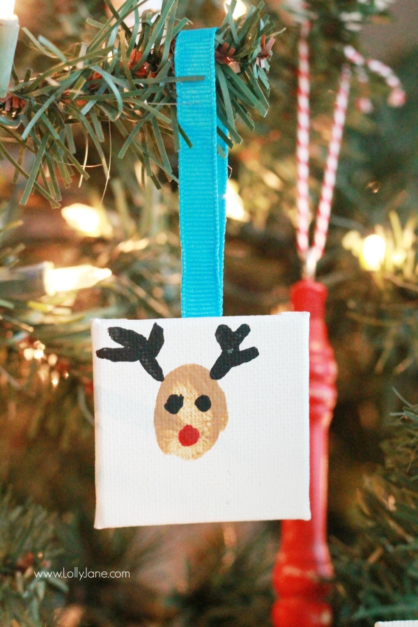 ADORABLE mini canvas thumbprint ornaments! SO EASY to make, kids have fun crafting and you get a Christmas keepsake for years to come. Great Christmas kids craft and Christmas gift idea! Love this reindeer thumbprint ornament!