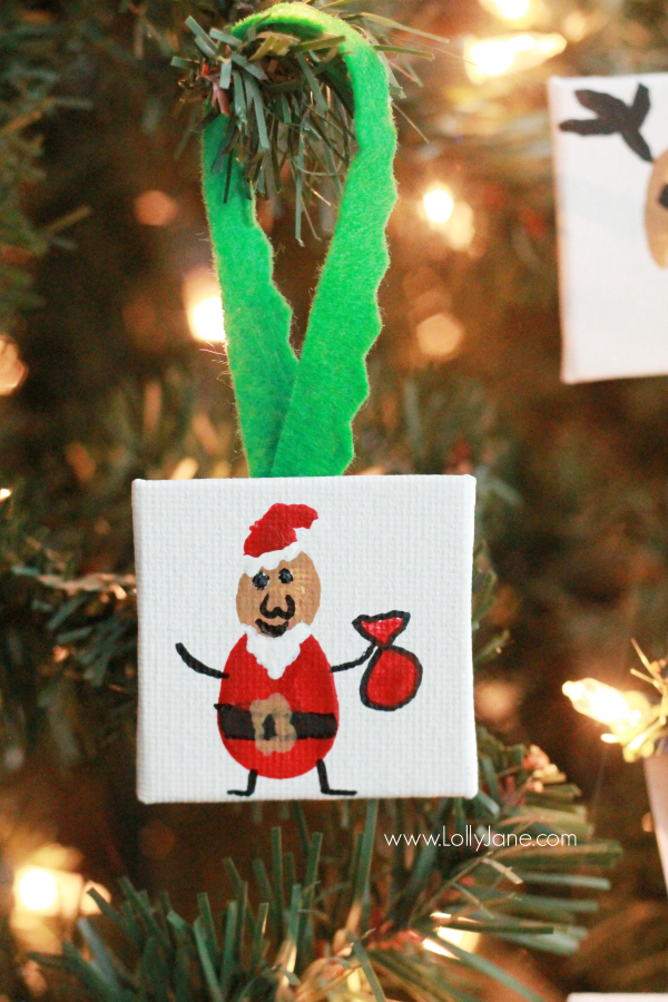 ADORABLE mini canvas thumbprint ornaments! SO EASY to make, kids have fun crafting and you get a Christmas keepsake for years to come. Great Christmas kids craft and Christmas gift idea! Love this Santa thumbprint ornament!