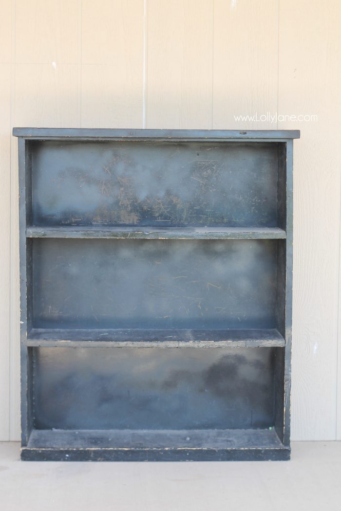 This old spray painted bookcase got a fresh coat of chalk paint and stamped backing, it looks amazing! CLICK through to the gorgeous after reveal! 