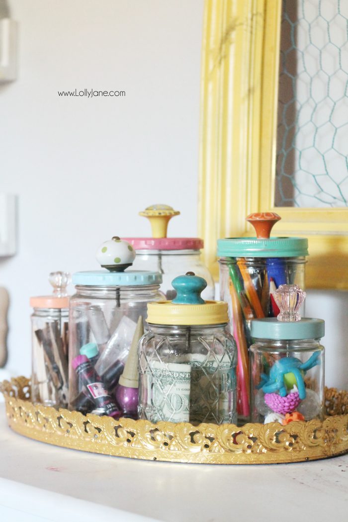 Add pretty knobs to the tops of mason jars for pretty mason jar storage solutions! Lots of options with this easy mason jar trick! Love these recycled food jars turned pretty storage jars with glass knobs!