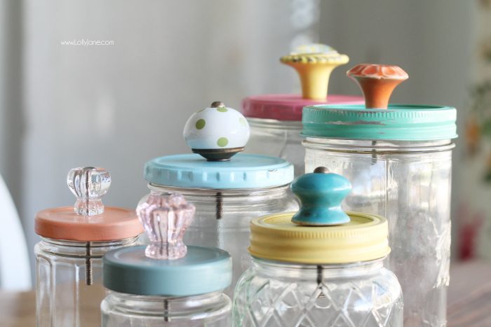 Add pretty knobs to the tops of mason jars for pretty mason jar storage solutions! Lots of options with this easy mason jar trick! Love these recycled food jars turned pretty storage jars with glass knobs!