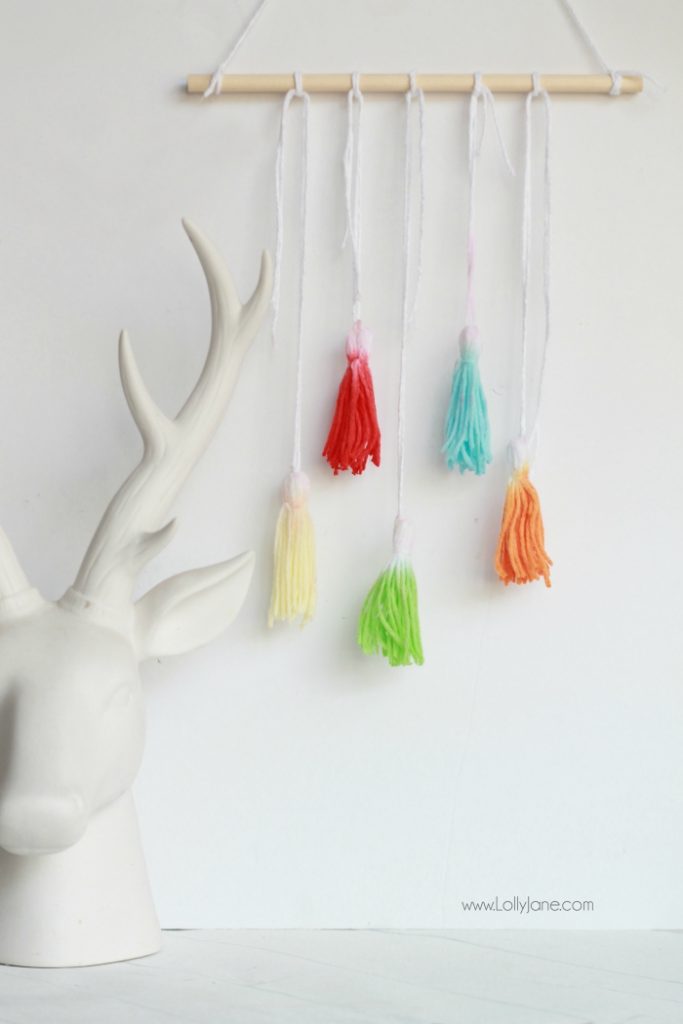 Check out this fun DIY Kool Aid Dip Dye Tassel Wall Hanging, cute backdrop idea, adorable home decor or fun craft idea!