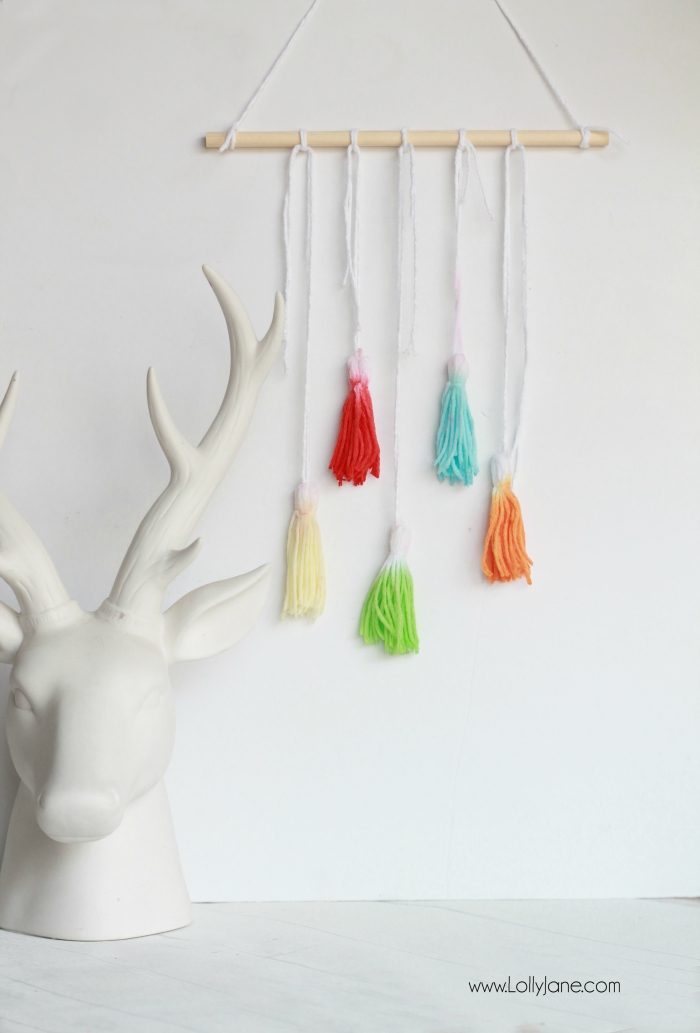 Check out this fun DIY Kool Aid Dip Dye Tassel Wall Hanging, cute backdrop idea, adorable home decor or fun craft idea!