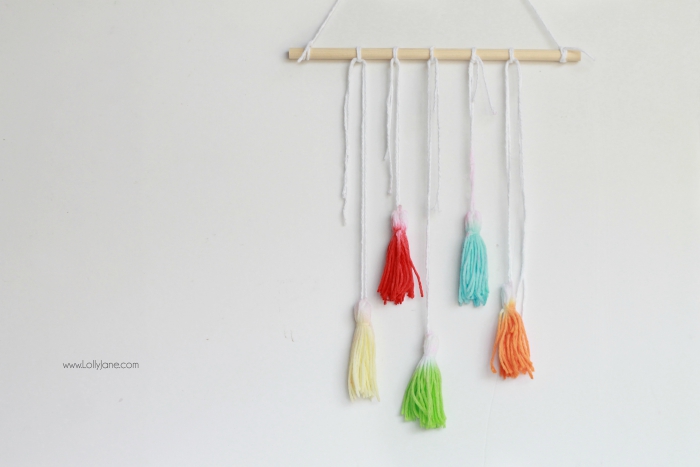 Check out this fun DIY Kool Aid Dip Dye Tassel Wall Hanging, cute backdrop idea, adorable home decor or fun craft idea!