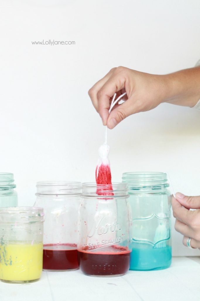 Check out this fun DIY Kool Aid Dip Dye Tassel Wall Hanging, cute backdrop idea, adorable home decor or fun craft idea!