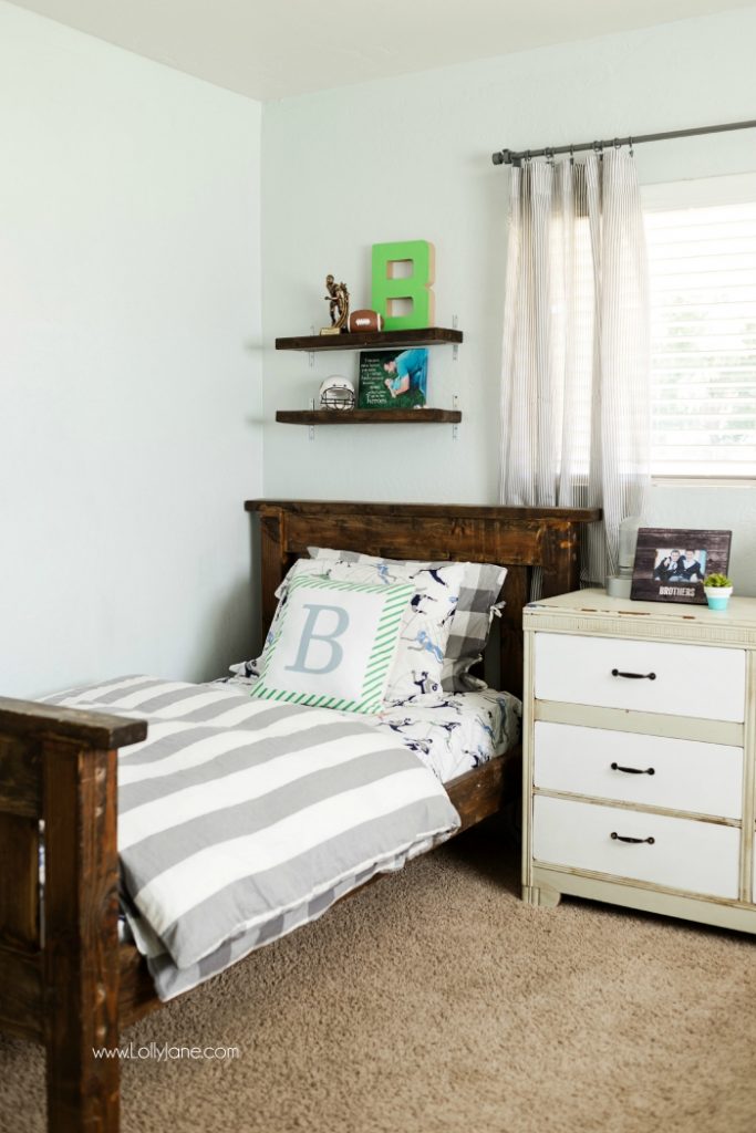 Vintage Industrial Boys Bedroom. Lots of wood tones, grays and neutrals for a vintage industrial boys bedroom. Cute decor ideas and tips to keep it neat. Fun accessories like a basketball hoop and green lockers to complete the space.