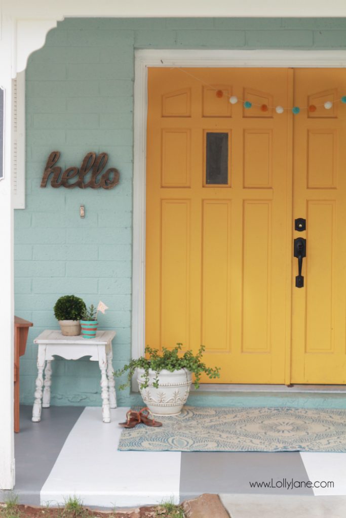 DIY painted striped concrete flooring. Check out this cute gray and white striped porch, easy way to freshen up your porch! Cute front porch decor!