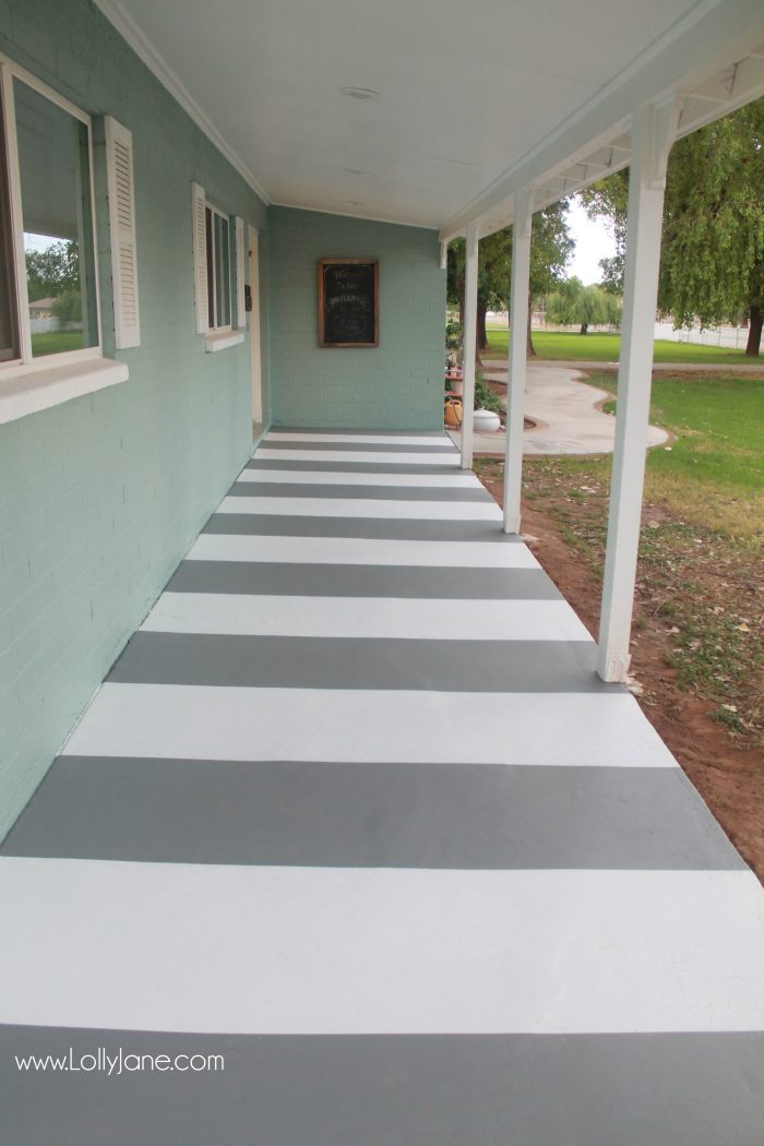 DIY painted striped concrete flooring. Check out this cute gray and white striped porch, easy way to freshen up your porch! Cute front porch decor!