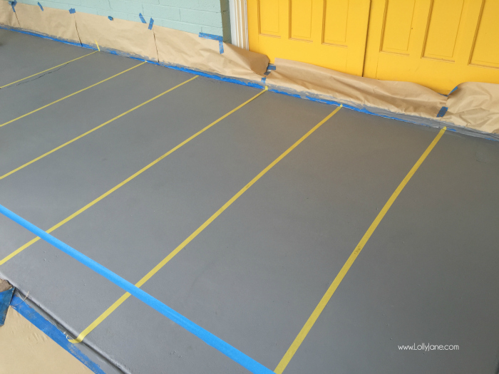 How to paint concrete floors: use a concrete paint porch and floor paint for secure adhesion. Click through for an awesome striped porch makeover.