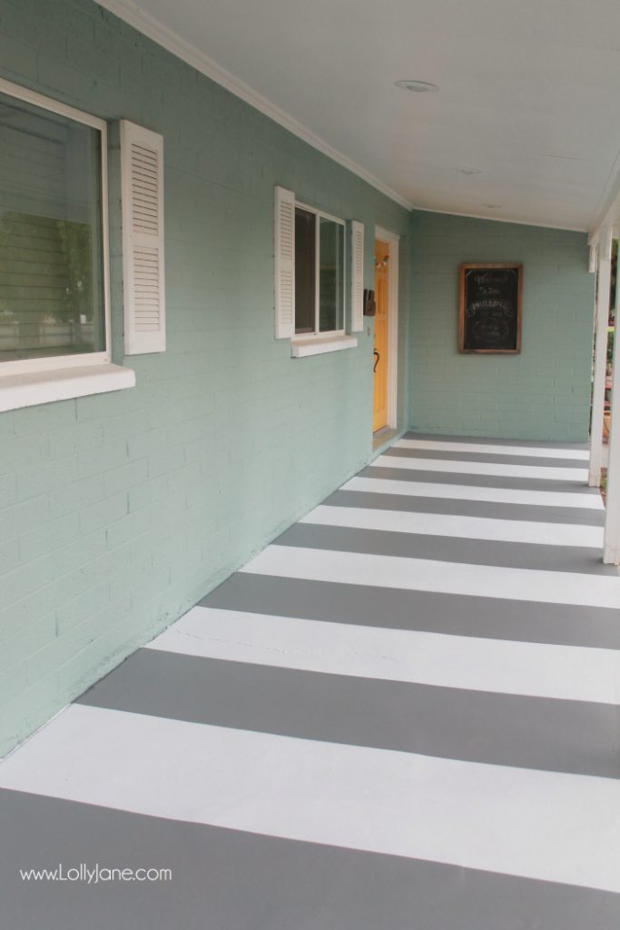 DIY painted striped concrete flooring. Check out this cute gray and white striped porch, easy way to freshen up your porch! Cute front porch decor!