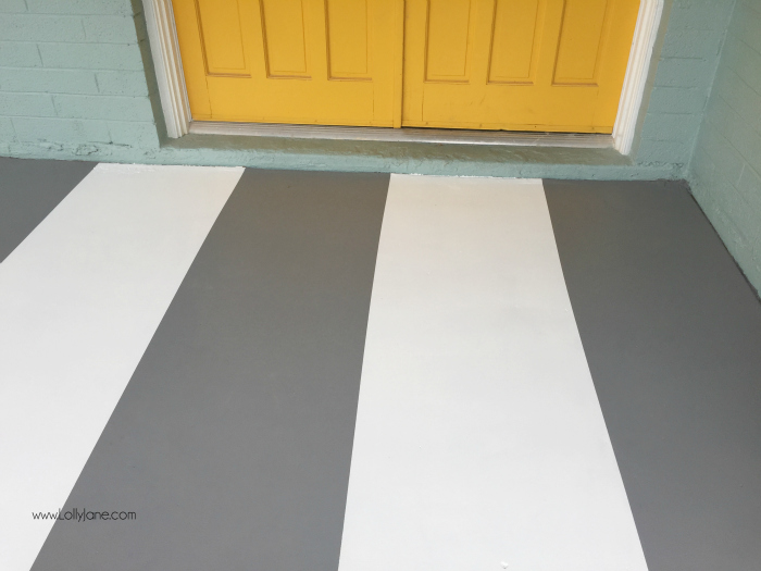 How to paint concrete floors: use a concrete paint porch and floor paint for secure adhesion. Click through for an awesome striped porch makeover.