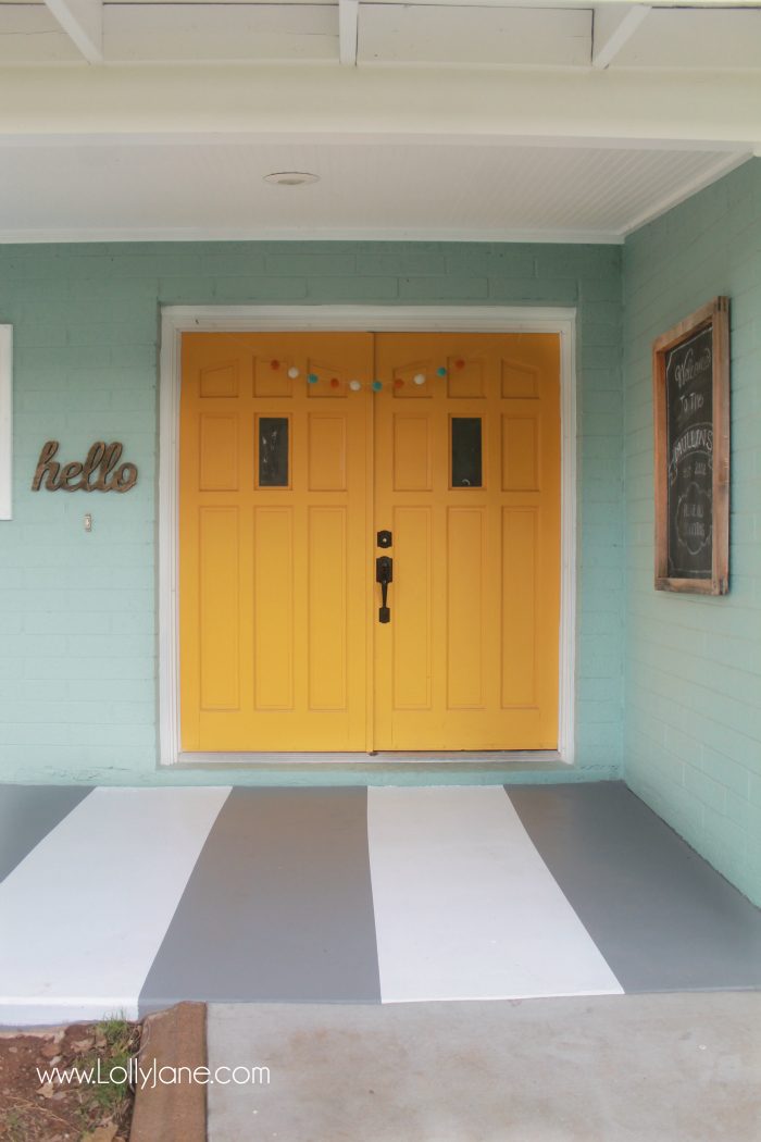 DIY painted striped concrete flooring. Check out this cute gray and white striped porch, easy way to freshen up your porch! Cute front porch decor!