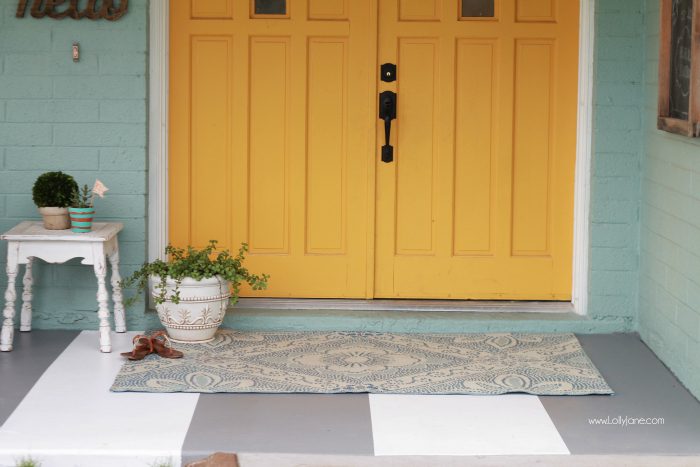 DIY painted striped concrete flooring. Check out this cute gray and white striped porch, easy way to freshen up your porch! Cute front porch decor!