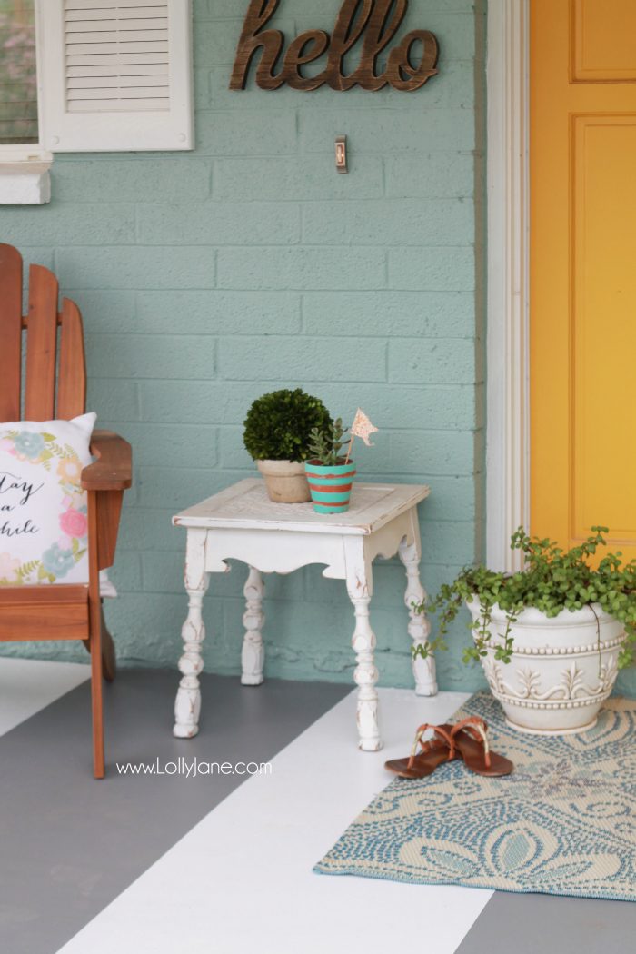 DIY painted striped concrete flooring. Check out this cute gray and white striped porch, easy way to freshen up your porch! Cute front porch decor!