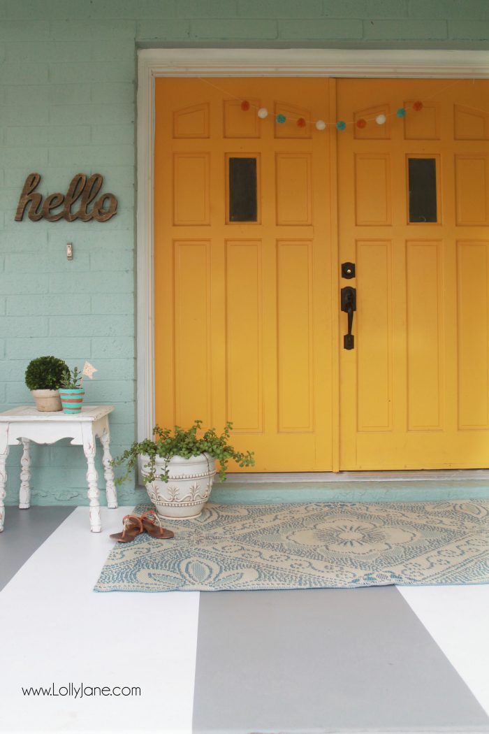 DIY painted striped concrete flooring. Check out this cute gray and white striped porch, easy way to freshen up your porch! Cute front porch decor!