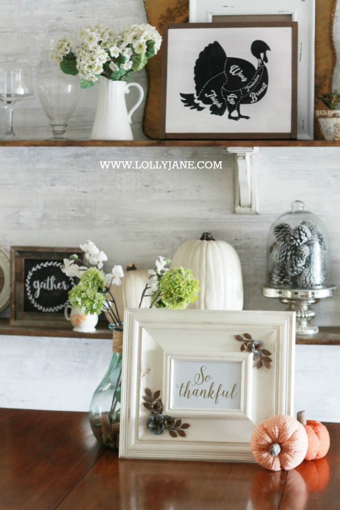 Beautiful farmhouse Thanksgiving dining room decorations. Decorate the table and shelves in layers of pumpkins and signs, fill in with greenery, books and pinecones. Cute Thanksgiving decor ideas that you can easily copy!