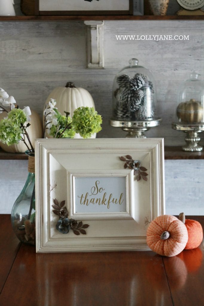 Beautiful farmhouse Thanksgiving dining room decorations. Decorate the table and shelves in layers of pumpkins and signs, fill in with greenery, books and pinecones. Cute Thanksgiving decor ideas that you can easily copy!