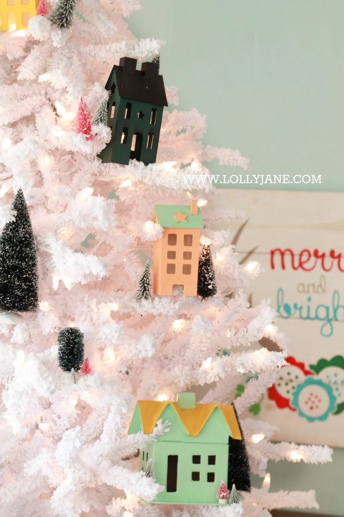Darling Christmas tree! Love this winter village Christmas tree with Putz houses and bottle brush trees! Fun colorful Christmas tree idea!