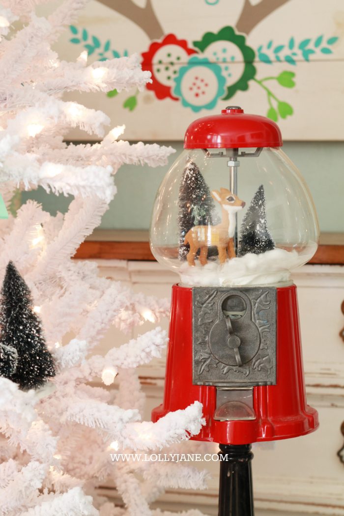 Adorable bottle brush tree gumball machine snow globe! Just stretch cotton balls for snow, set a mini deer + bottle brush trees in a red gumball machine. Cute display via @lollyjaneblog | lollyjane.com