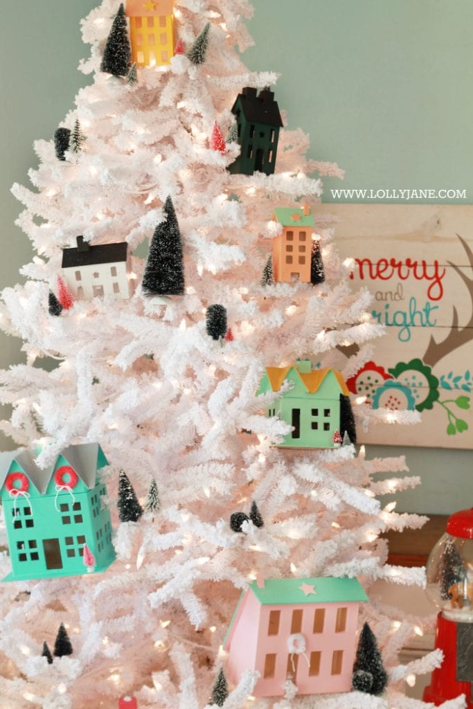 Darling Christmas tree! Love this winter village Christmas tree with Putz houses and bottle brush trees! Fun colorful Christmas tree idea!