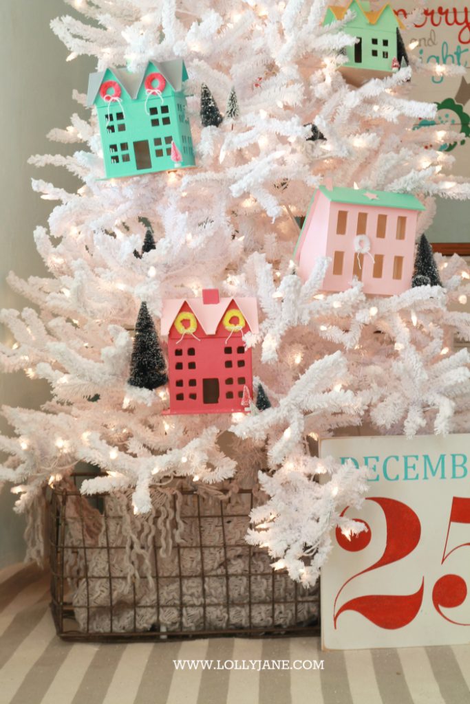 Darling Christmas tree! Love this winter village Christmas tree with Putz houses and bottle brush trees! Fun colorful Christmas tree idea!