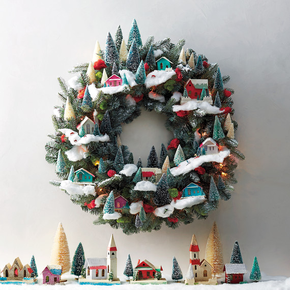 Love this easy DIY Village Christmas Wreath... and those bottle brush trees in it! LOVE! So easy to recreate this look, take a peek! #diy #bottlebrushtree #christmastree #christmasdecorations #christmasvillage