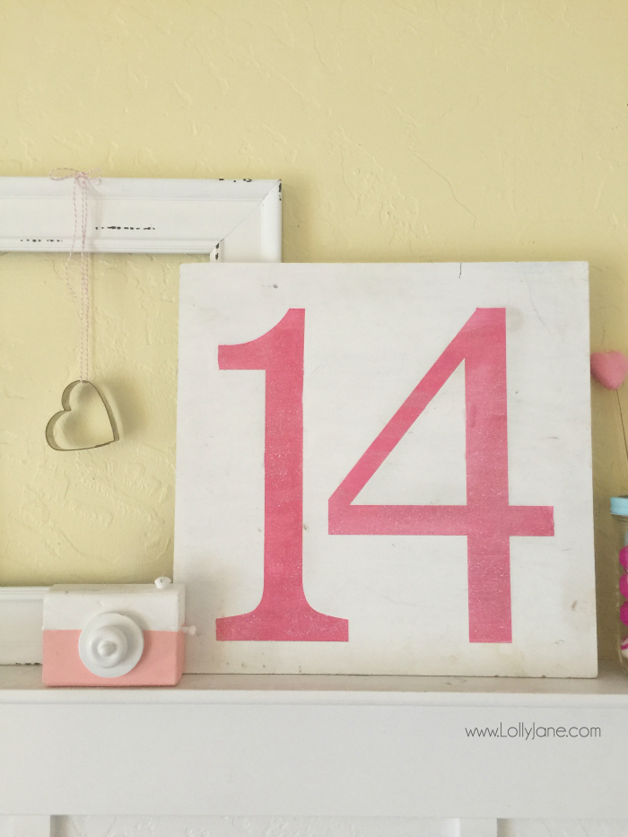 Easy Valentines Day mantel. Layer an empty frame, quick 14 sign for Valentine's Day mantel decor then fill in with random coordinating accessories. Love this easy Valentine's Day mantel!