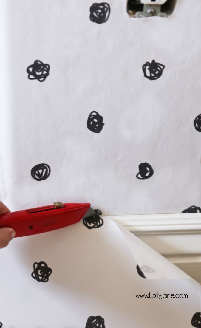 Wondering how to cut wallpaper panels when using peel and stick wallpaper? Use an XActo Knife to cut the end of the wallpaper panel at the baseboard, so easy to get a perfect cut when cutting downward. #wallpapertip #peelstickwallpaper #howtoapplywallpaper #polkadotwallaccent #blackwhitewallpaper