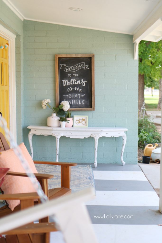 Summer porch decor ideas! Love the pops of coral and bright summer colors! New vases with colorful flowers really brighten up this summer porch! Great summer porch decor ideas!