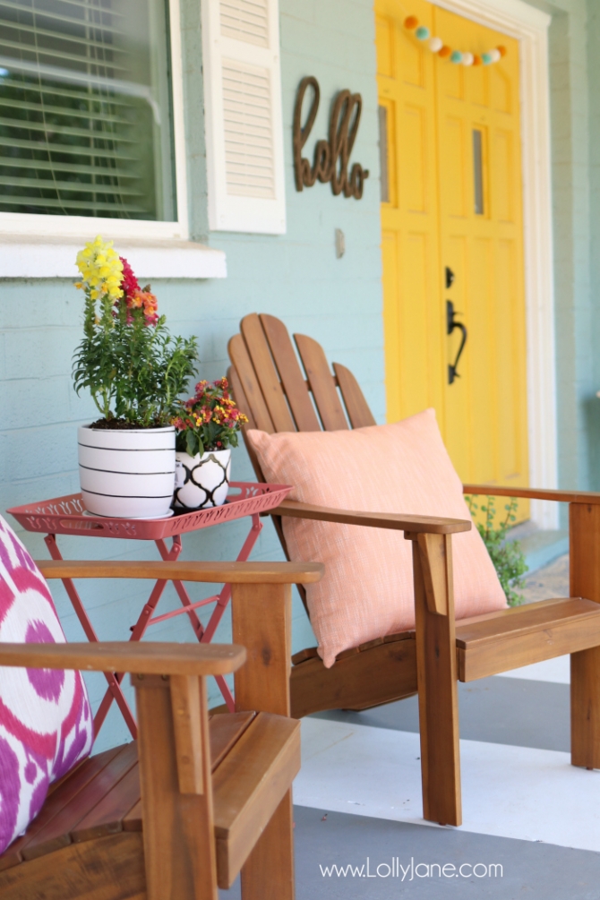 Summer porch decor ideas! Love the pops of coral and bright summer colors! New vases with colorful flowers really brighten up this summer porch! Great summer porch decor ideas!