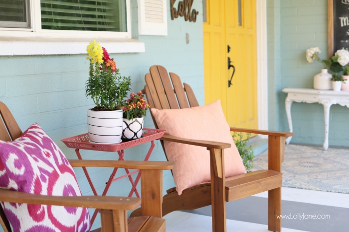 Summer porch decor ideas! Love the pops of coral and bright summer colors! New vases with colorful flowers really brighten up this summer porch! Great summer porch decor ideas!