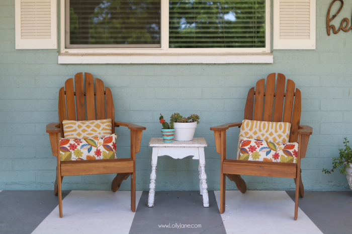 Summer porch decor ideas! Love the pops of coral and bright summer colors! New vases with colorful flowers really brighten up this summer porch! Great summer porch decor ideas!