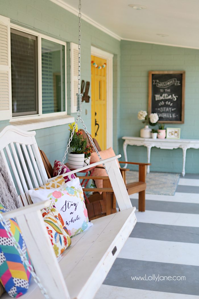 Summer porch decor ideas! Love the pops of coral and bright summer colors! New vases with colorful flowers really brighten up this summer porch! Great summer porch decor ideas!