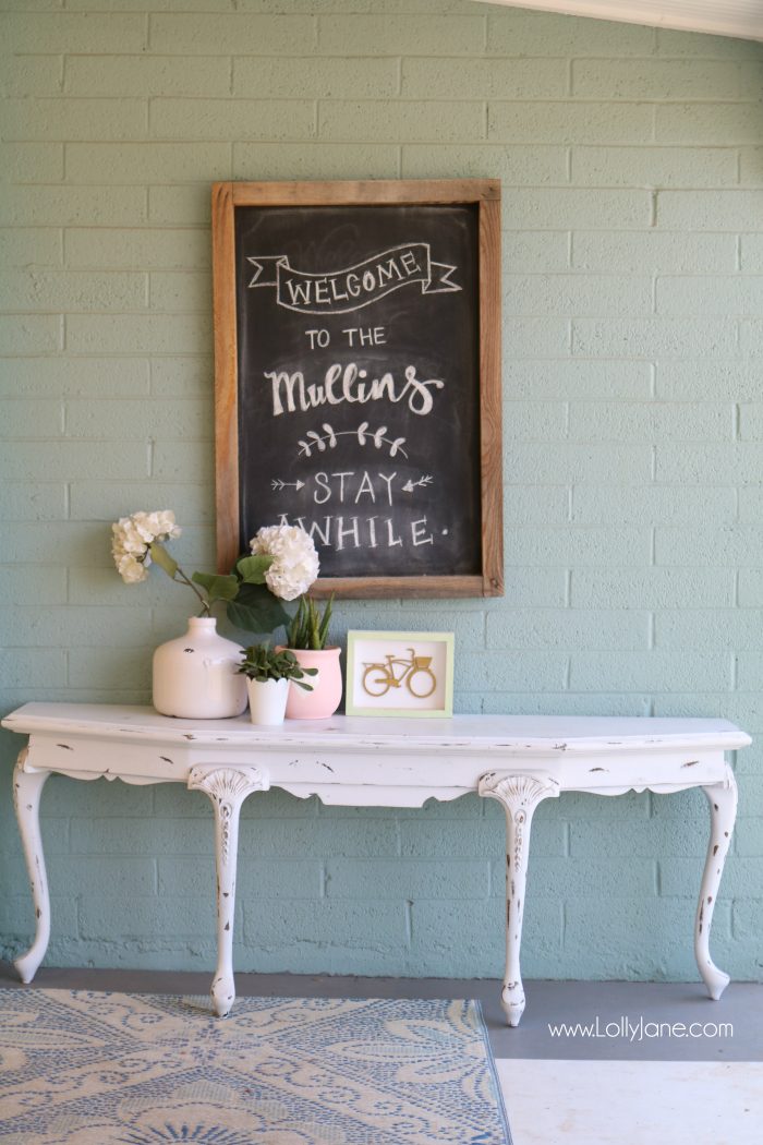 Summer porch decor ideas! Love the pops of coral and bright summer colors! New vases with colorful flowers really brighten up this summer porch! Great summer porch decor ideas!