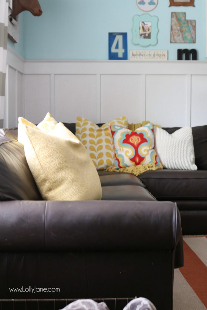 Pretty colorful farmhouse family room decor. Easy ways to pull together a family room space. Pretty farmhouse decor ideas. Love this colorful family room! These billy balls in vintage blue mason jars are such cute decor too. Pretty blue wingback accent chairs complete the space!