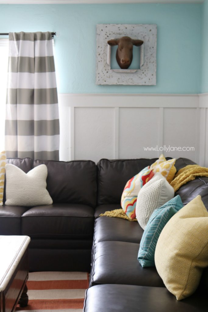 Pretty colorful farmhouse family room decor. Easy ways to pull together a family room space. Pretty farmhouse decor ideas. Love this colorful family room! These billy balls in vintage blue mason jars are such cute decor too. We love our La-Z-Boy leather couches, very comfortable!