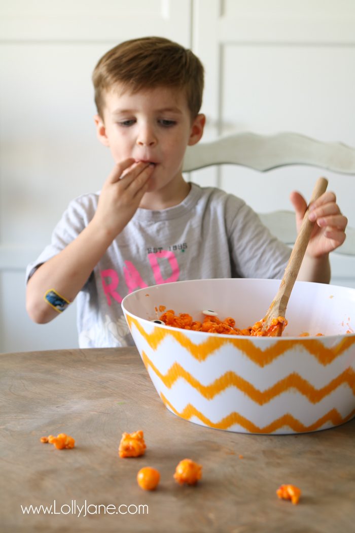 Easy and YUMMY Candy Covered Halloween Popcorn! Perfect for little hands to help in the kitchen, then bag up for a spooky treat!