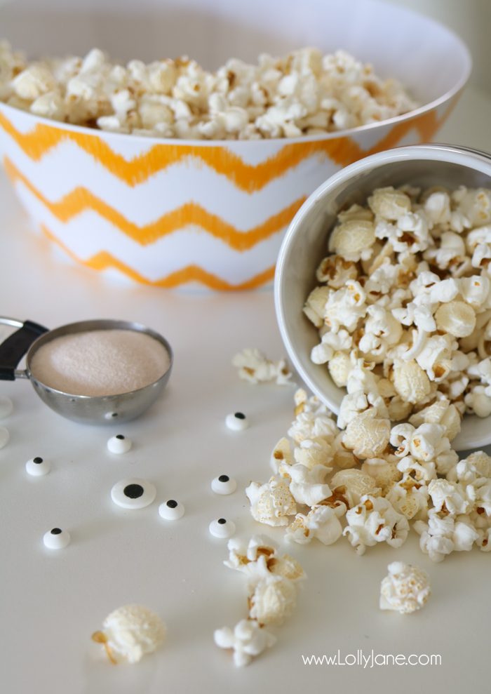 Easy and YUMMY Candy Covered Halloween Popcorn! Perfect for little hands to help in the kitchen, then bag up for a spooky treat!