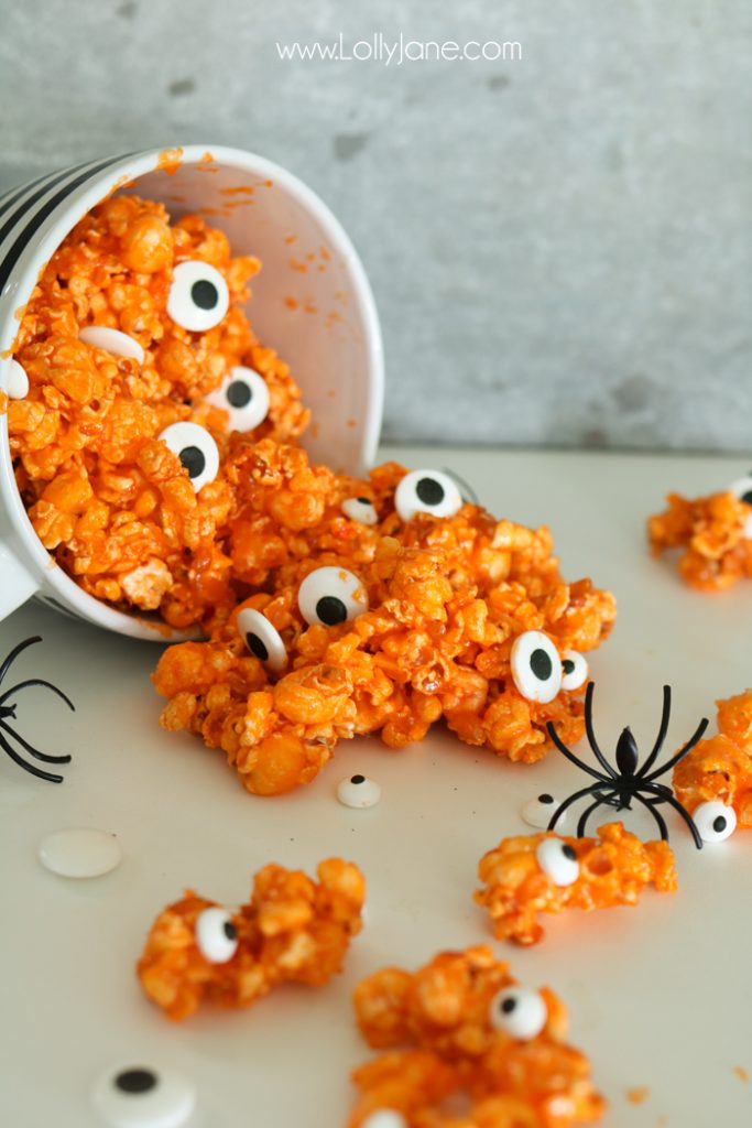 Easy and YUMMY Candy Covered Halloween Popcorn! Perfect for little hands to help in the kitchen, then bag up for a spooky treat!