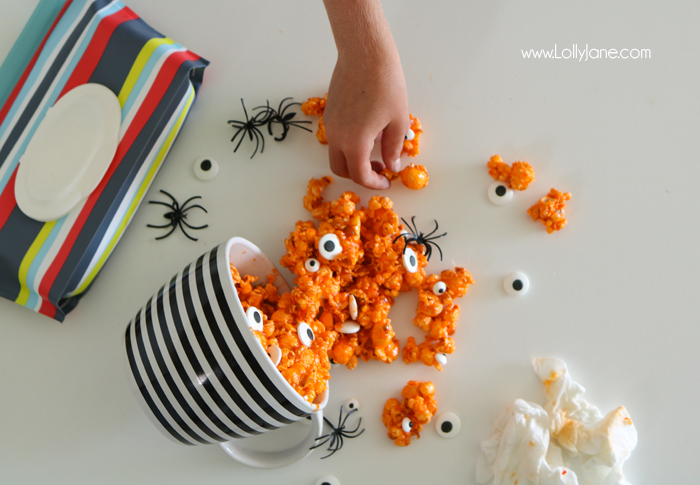 Easy and YUMMY Candy Covered Halloween Popcorn! Perfect for little hands to help in the kitchen, then bag up for a spooky treat!